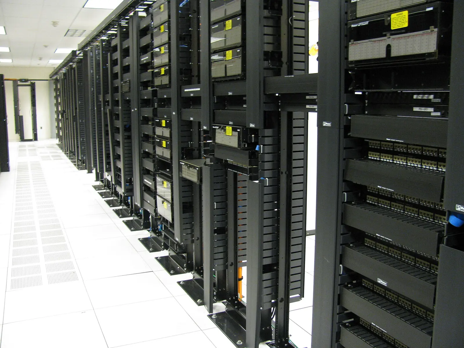 A row of rack-mounted servers and network equipment in a data-centre aisle