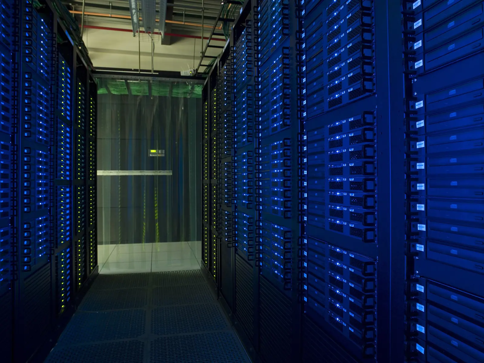 Blue-lit server cabinets and cable racks at the Fermilab grid computing centre