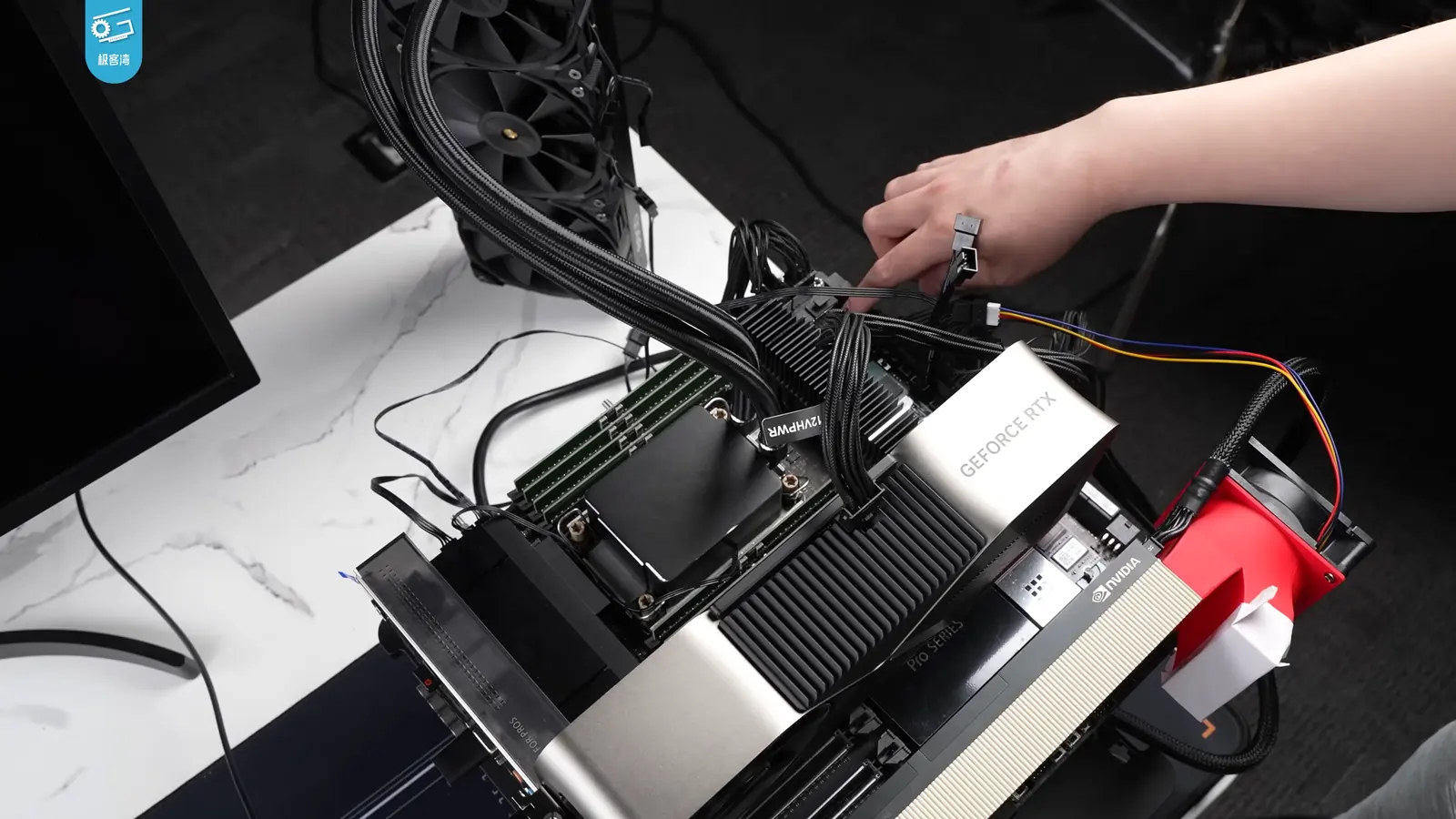 Hands connecting power cables to NVIDIA H100 GPUs in a hardware test system