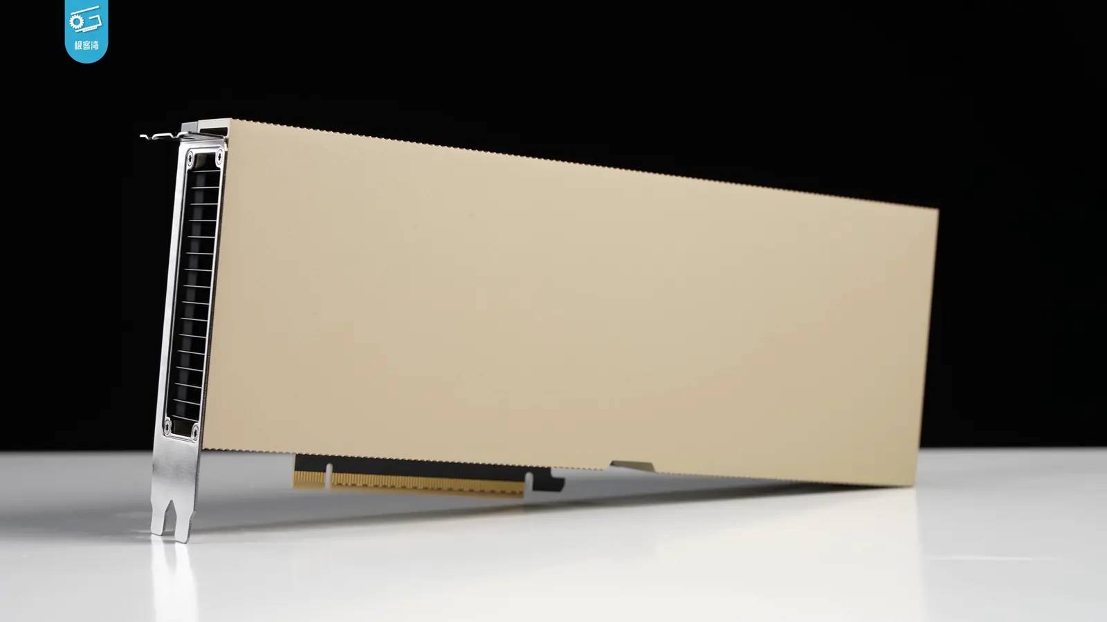 NVIDIA H100 PCIe GPU accelerator photographed on a white workbench against a dark background