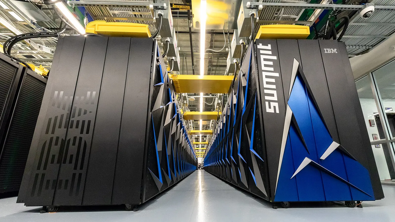 Rows of Summit supercomputer cabinets and overhead infrastructure at Oak Ridge National Laboratory