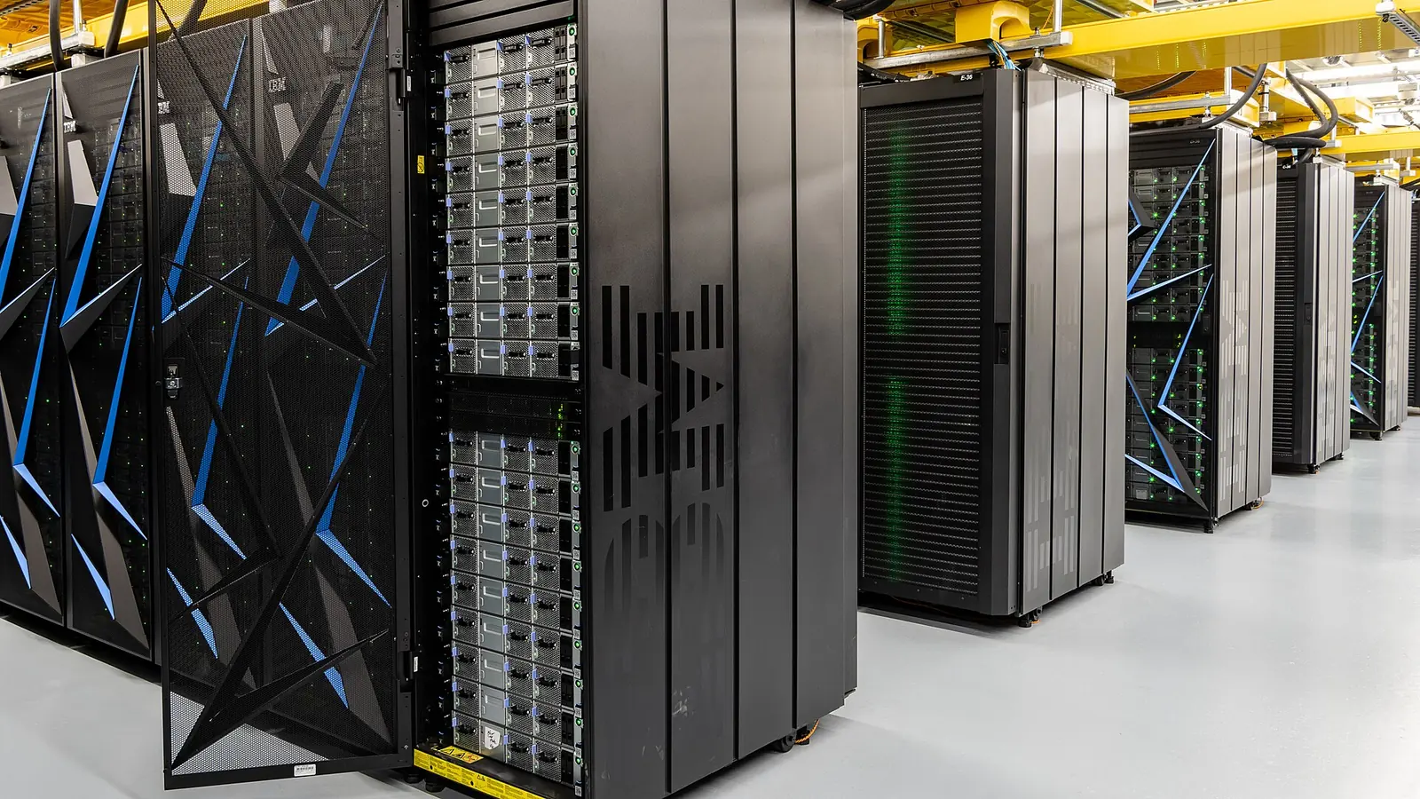 Summit supercomputer cabinets showing rack doors, cabling and the adjacent compute row