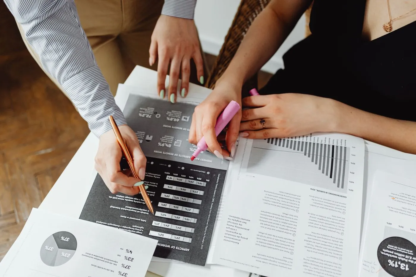 Colleagues reviewing charts and reports at a table
